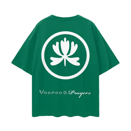 Green oversized t-shirt with bold white lotus flower graphic and decorative script text on back.