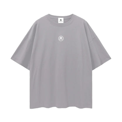 Oversized grey t-shirt with small white logo graphic on chest, minimalist streetwear style