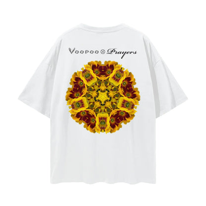 White oversized T-shirt with a kaleidoscope yellow flower pattern and 'Voodoo & Prayers' text on the back