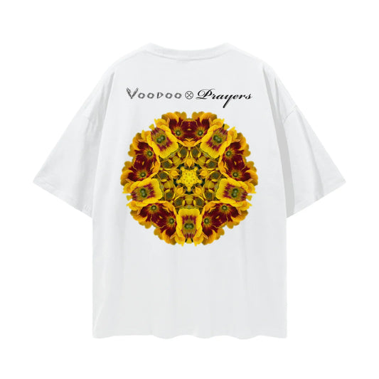White oversized T-shirt with a kaleidoscope yellow flower pattern and 'Voodoo & Prayers' text on the back